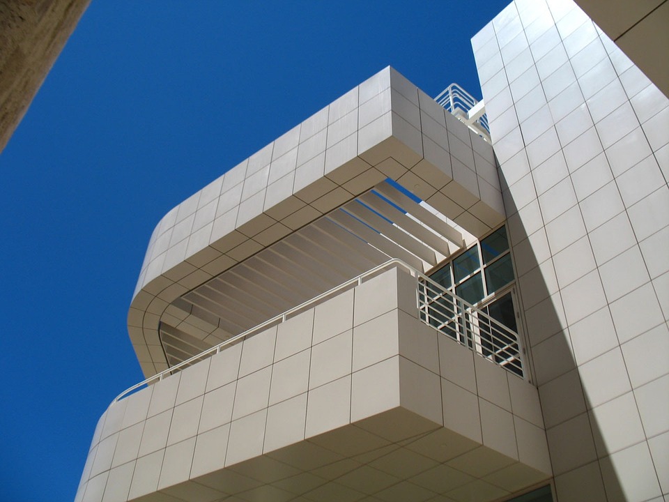 The exterior of the Getty Center building in Los Angeles; the white exterior of the building juts up against a blue, clear sky.