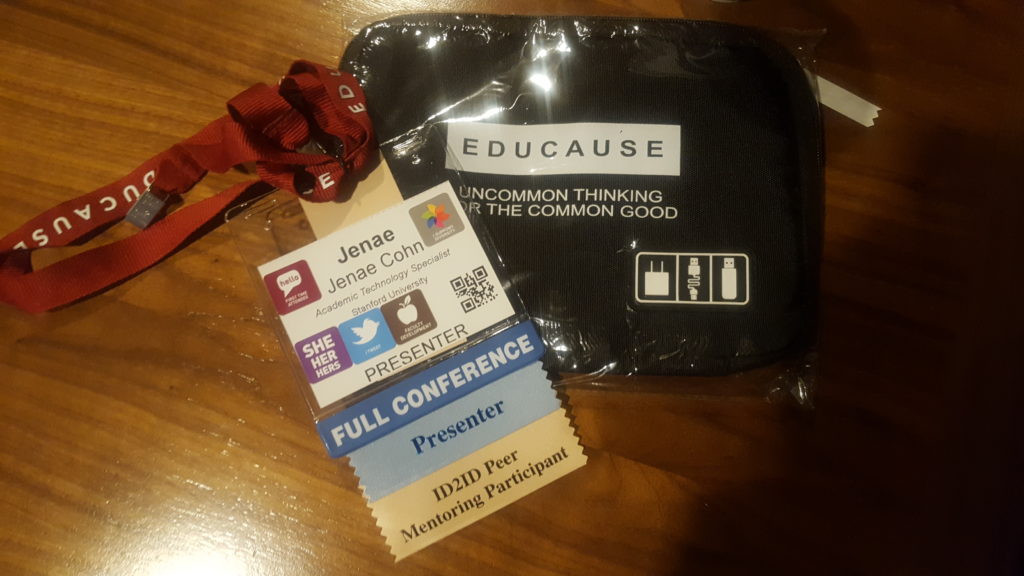 A conference badge with a lot of stickers is displayed on a table to showcase engagement at the ELI conference.